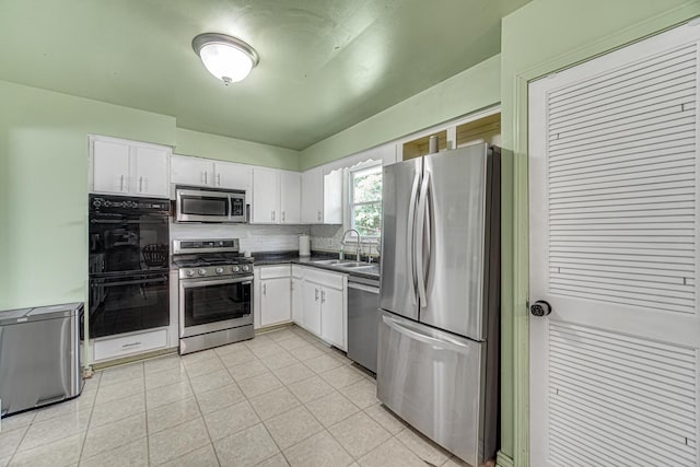 1306 Monroe St, Lake In The Hills, IL 60156 - kitchen with stainless steel appliances, dark countertops, white cabinets, and decorative backsplash