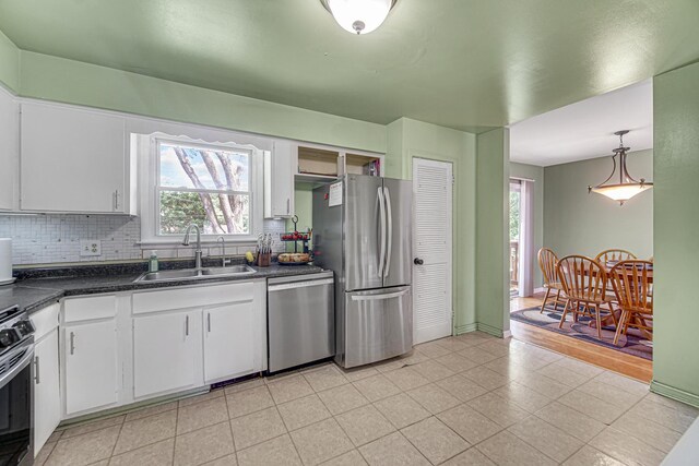 1306 Monroe St, Lake In The Hills, IL 60156 - kitchen featuring stainless steel appliances, backsplash, dark countertops, and healthy amount of natural light