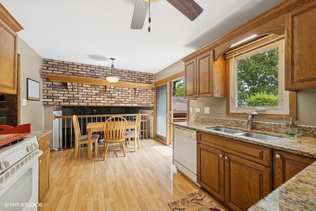 1127 Alpine Ln, Lemont, IL 60439 - kitchen featuring white appliances, light wood finished floors, brown cabinetry, a brick fireplace, and ceiling fan