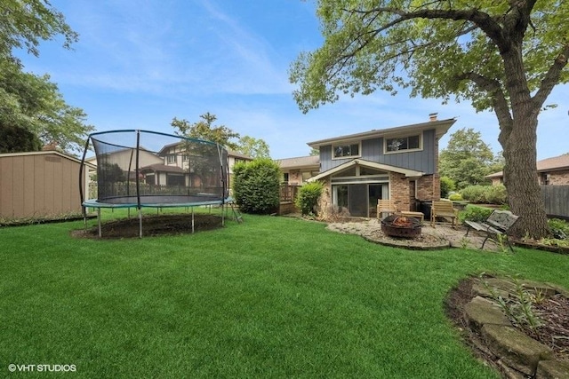 1127 Alpine Ln, Lemont, IL 60439 - back of house featuring an outdoor fire pit, a trampoline, a storage shed, and brick siding