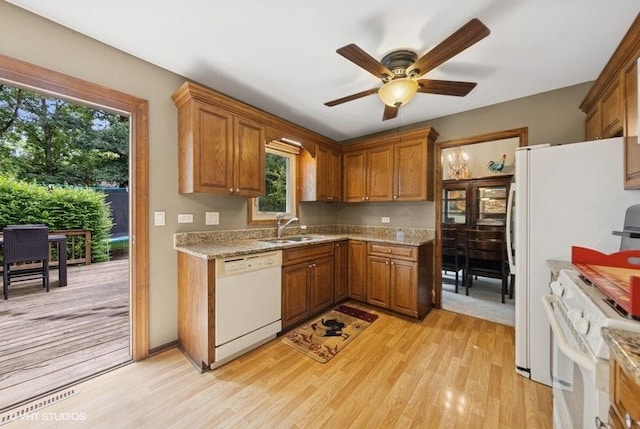 1127 Alpine Ln, Lemont, IL 60439 - kitchen featuring white appliances, light wood-type flooring, brown cabinets, a ceiling fan, and light stone counters