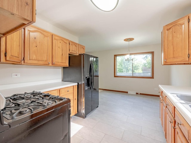 15117 La Crosse Ave, Oak Forest, IL 60452 - kitchen featuring black appliances, light countertops, light brown cabinets, and decorative light fixtures