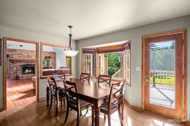 23 Colony Ct, Yorkville, IL 60560 - dining area with wood finished floors and a fireplace