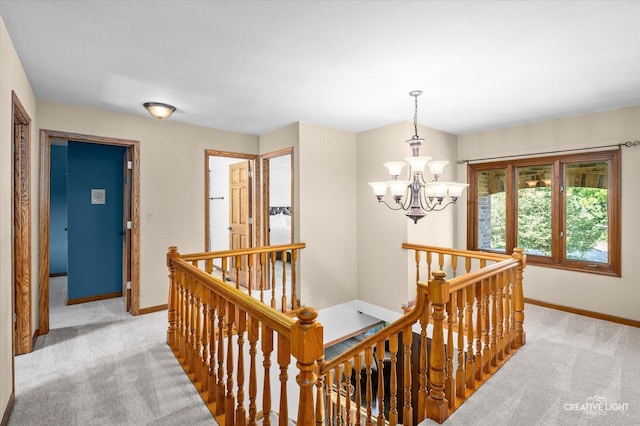 23 Colony Ct, Yorkville, IL 60560 - hall with an upstairs landing, light carpet, and a chandelier