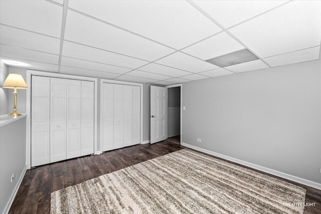 23 Colony Ct, Yorkville, IL 60560 - unfurnished bedroom with wood finished floors, a drop ceiling, and two closets