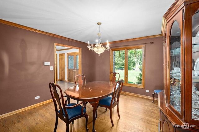23 Colony Ct, Yorkville, IL 60560 - dining area featuring a chandelier, crown molding, and light wood-type flooring