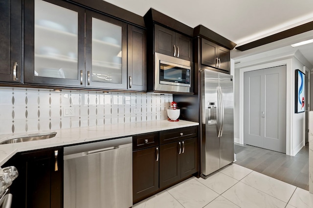 400 E Randolph St Unit 2603, Chicago, IL 60601 - kitchen with stainless steel appliances, light stone countertops, tasteful backsplash, glass insert cabinets, and dark brown cabinetry