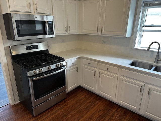 38 King Arthur Ct Unit 14, Northlake, IL 60164 - kitchen featuring appliances with stainless steel finishes, white cabinets, dark wood finished floors, and light countertops