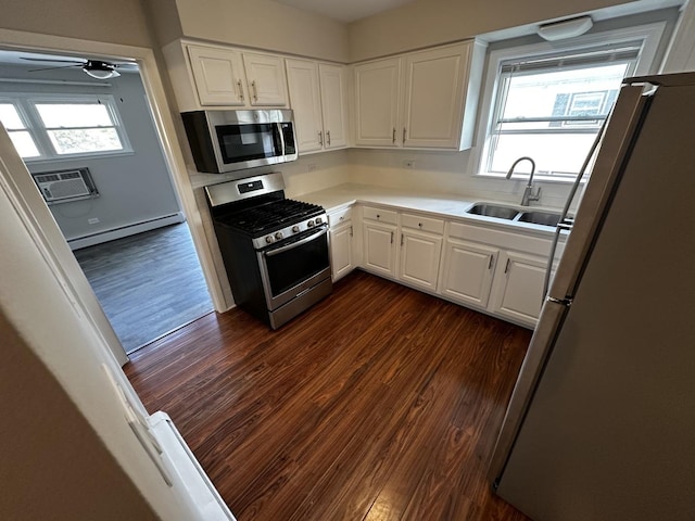 38 King Arthur Ct Unit 14, Northlake, IL 60164 - kitchen with appliances with stainless steel finishes, baseboard heating, dark wood-style flooring, and white cabinetry