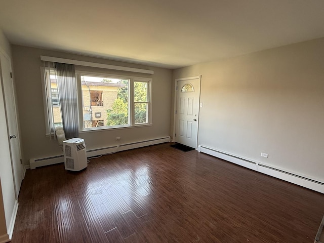 38 King Arthur Ct Unit 14, Northlake, IL 60164 - spare room featuring a baseboard heating unit and dark wood finished floors
