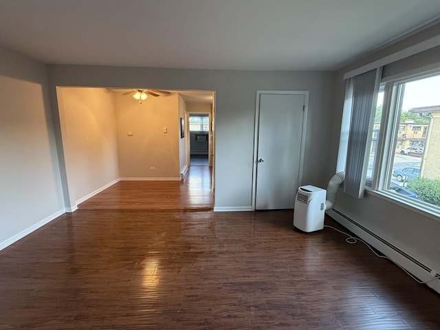 38 King Arthur Ct Unit 14, Northlake, IL 60164 - spare room featuring dark wood finished floors, a baseboard radiator, and a ceiling fan