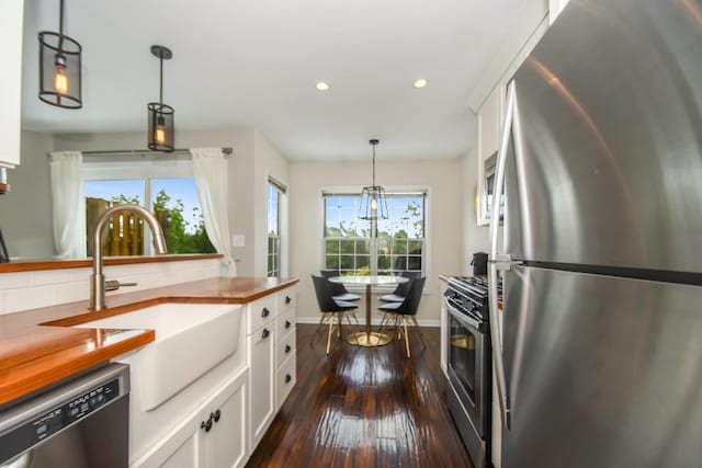 27W415 Providence Ln Unit 103, Winfield, IL 60190 - kitchen with stainless steel appliances, recessed lighting, dark wood-style flooring, white cabinetry, and decorative light fixtures
