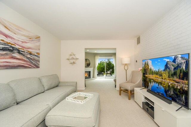 27W415 Providence Ln Unit 103, Winfield, IL 60190 - living area with light colored carpet and a warm lit fireplace