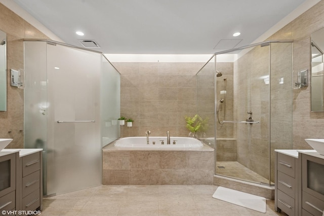 401 N Wabash Ave Unit 44F, Chicago, IL 60611 - full bath with vanity, a garden tub, a stall shower, tile patterned flooring, and tile walls