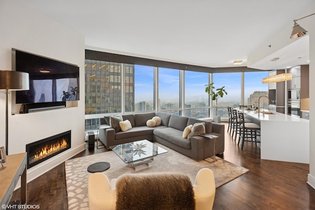 401 N Wabash Ave Unit 44F, Chicago, IL 60611 - living area featuring dark wood-style floors, a warm lit fireplace, a view of city, and floor to ceiling windows