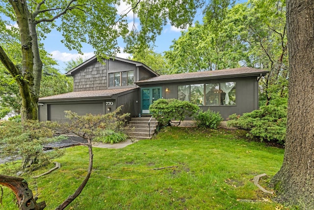 770 Yosemite Trl, Roselle, IL 60172 - tri-level home featuring a front lawn, an attached garage, and roof with shingles