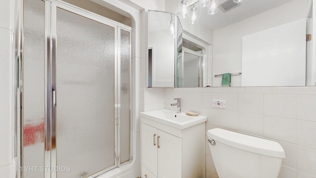 2333 Catherine St, Northbrook, IL 60062 - full bath with vanity, a shower stall, tasteful backsplash, and tile walls
