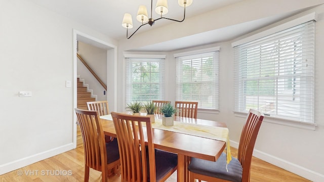 2333 Catherine St, Northbrook, IL 60062 - dining area featuring light wood-style flooring, a chandelier, and stairway