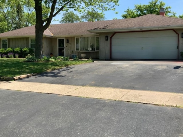 1412 Timberline Dr, Joliet, IL 60431 - ranch-style home with asphalt driveway, a chimney, an attached garage, and board and batten siding