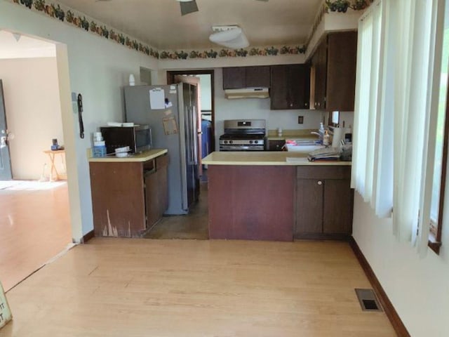 1412 Timberline Dr, Joliet, IL 60431 - kitchen with appliances with stainless steel finishes, under cabinet range hood, light wood-style flooring, and a peninsula