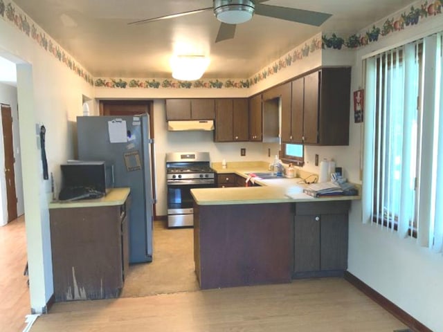1412 Timberline Dr, Joliet, IL 60431 - kitchen featuring stainless steel appliances, under cabinet range hood, a ceiling fan, a peninsula, and light wood-style flooring