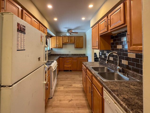 1840 W Hatherleigh Ct Unit 1E, Mount Prospect, IL 60056 - kitchen featuring white appliances, brown cabinetry, dark countertops, light wood-style flooring, and recessed lighting