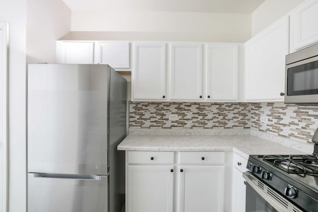 3317 Stratford Ct Unit 2E, Lake Bluff, IL 60044 - kitchen with stainless steel appliances, tasteful backsplash, white cabinets, and light stone counters