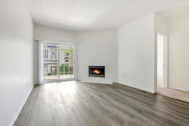 3317 Stratford Ct Unit 2E, Lake Bluff, IL 60044 - unfurnished living room with wood finished floors and a tile fireplace