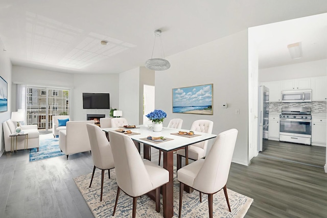 3317 Stratford Ct Unit 2E, Lake Bluff, IL 60044 - dining room featuring wood finished floors and a warm lit fireplace