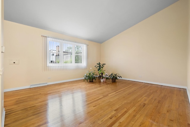 535 Glenshire Rd, Glenview, IL 60025 - unfurnished room with vaulted ceiling, light wood-style floors, and a baseboard radiator