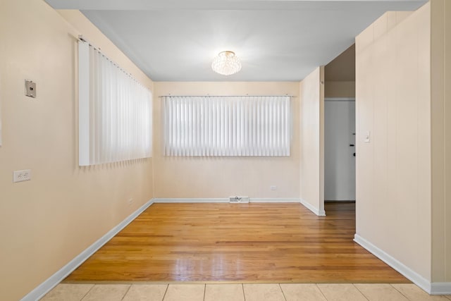 535 Glenshire Rd, Glenview, IL 60025 - tiled spare room with baseboards and a chandelier
