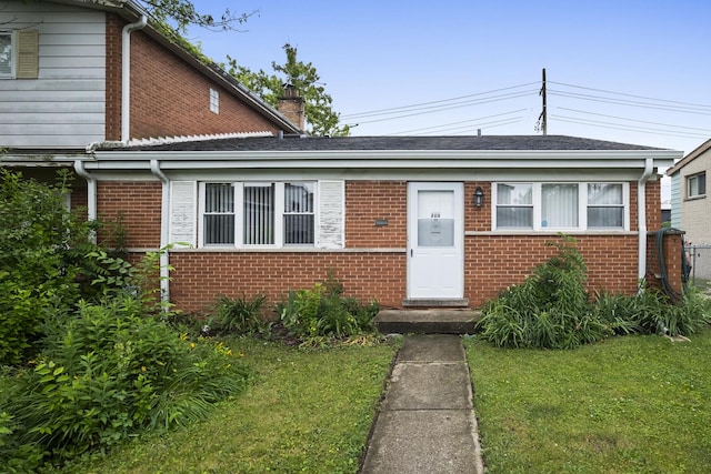 535 Glenshire Rd, Glenview, IL 60025 - view of front of property with brick siding, a front lawn, and a chimney