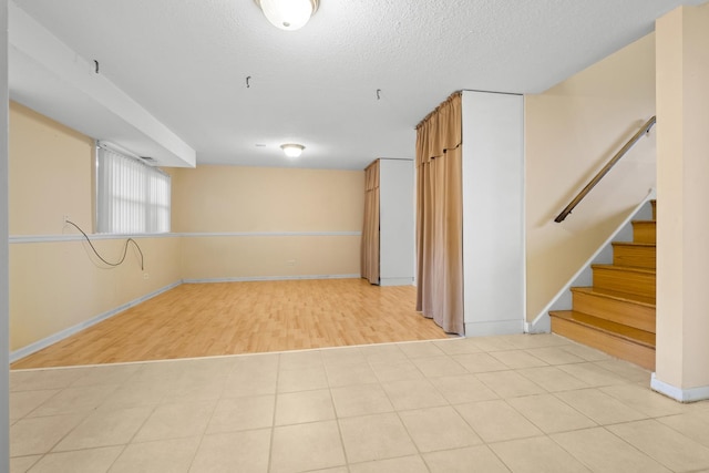 535 Glenshire Rd, Glenview, IL 60025 - unfurnished room with light wood finished floors, stairs, and a textured ceiling