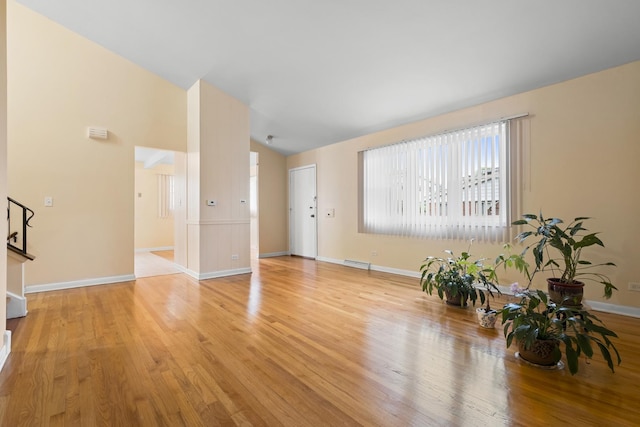 535 Glenshire Rd, Glenview, IL 60025 - unfurnished living room featuring vaulted ceiling and light wood-style flooring