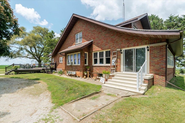 879 2300th Ave, Chestnut, IL 62518 - rear view of property with entry steps, a deck, brick siding, and a yard