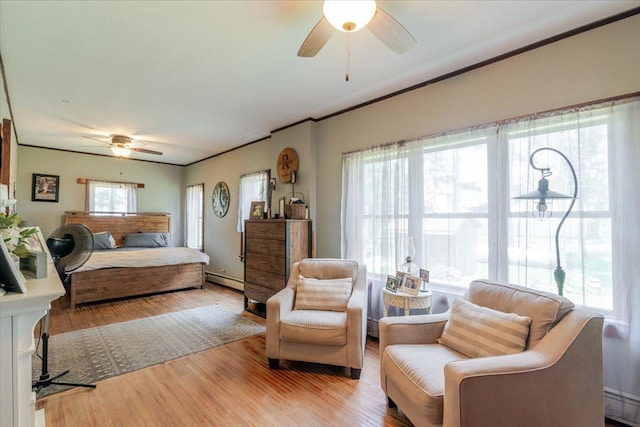 879 2300th Ave, Chestnut, IL 62518 - bedroom featuring wood finished floors, baseboard heating, crown molding, and ceiling fan