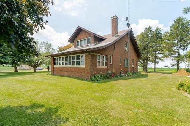879 2300th Ave, Chestnut, IL 62518 - view of home's exterior featuring brick siding, a lawn, and a chimney