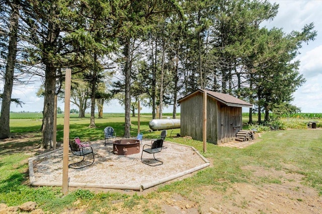 879 2300th Ave, Chestnut, IL 62518 - view of grassy yard featuring a fire pit and a storage shed
