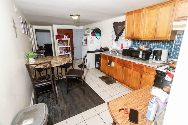 12400-02 S Green St, Calumet Park, IL 60827 - kitchen with black microwave, light tile patterned flooring, decorative backsplash, light countertops, and range with gas cooktop