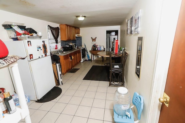 12400-02 S Green St, Calumet Park, IL 60827 - kitchen with brown cabinets, freestanding refrigerator, light tile patterned floors, and backsplash