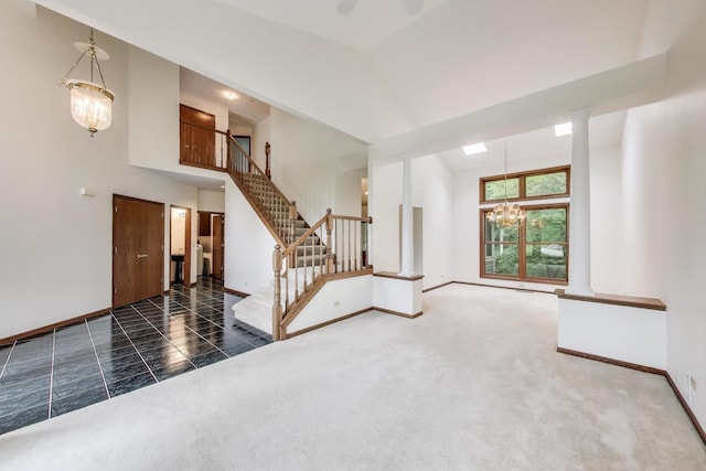 705 Wood Creek Dr, Antioch, IL 60002 - unfurnished living room featuring a chandelier, a high ceiling, stairway, and carpet