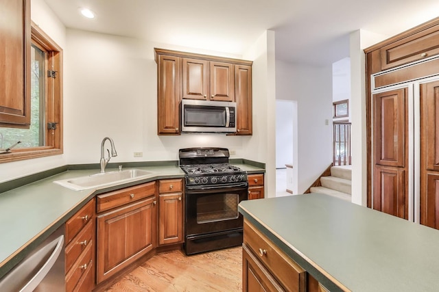 705 Wood Creek Dr, Antioch, IL 60002 - kitchen with appliances with stainless steel finishes, light wood finished floors, brown cabinets, and recessed lighting