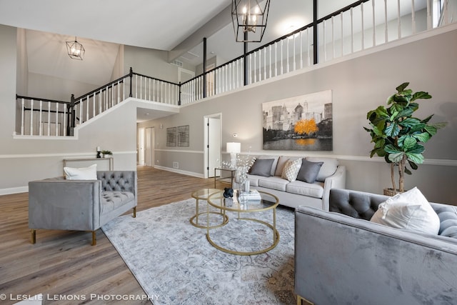 20936 Orange Blossom Ln, Plainfield, IL 60544 - living area with a high ceiling, wood finished floors, a chandelier, and stairs