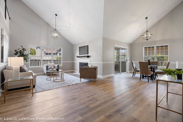 20936 Orange Blossom Ln, Plainfield, IL 60544 - living room featuring high vaulted ceiling, a chandelier, wood finished floors, and a fireplace
