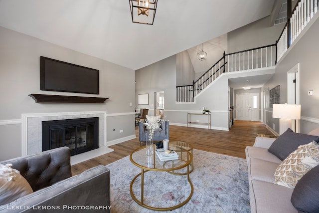 20936 Orange Blossom Ln, Plainfield, IL 60544 - living room with stairway, high vaulted ceiling, wood finished floors, and a glass covered fireplace