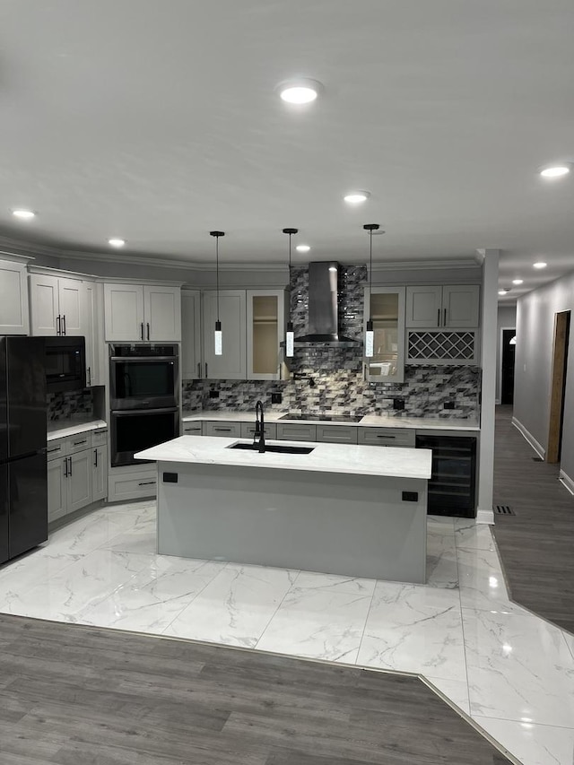 4629 S Langley Ave, Chicago, IL 60653 - kitchen with wall chimney exhaust hood, black appliances, gray cabinetry, beverage cooler, and backsplash