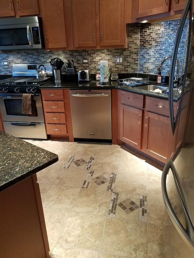 4629 S Langley Ave, Chicago, IL 60653 - kitchen with stainless steel appliances, decorative backsplash, and dark stone countertops
