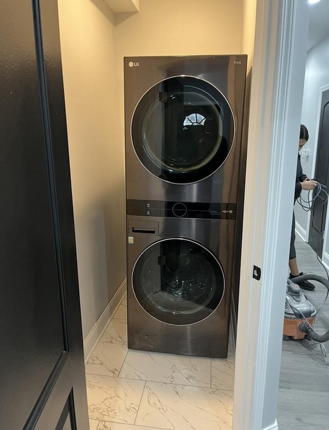 4629 S Langley Ave, Chicago, IL 60653 - washroom featuring estacked washer and dryer and marble finish flooring