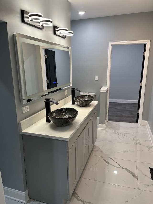 4629 S Langley Ave, Chicago, IL 60653 - bathroom with double vanity, marble look tiles, and recessed lighting