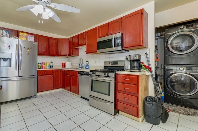 337 E Clark St, Glenwood, IL 60425 - kitchen with stainless steel appliances, stacked washer and clothes dryer, dark brown cabinets, light countertops, and decorative backsplash